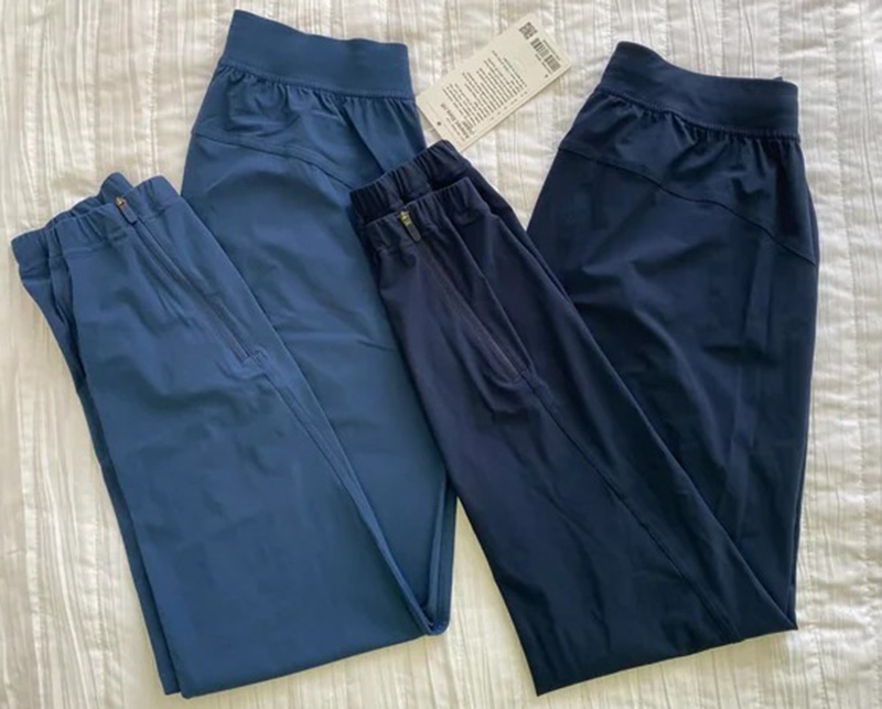 Three blue-toned jogger pants laid flat, showing elastic waistbands and tapered athletic fit