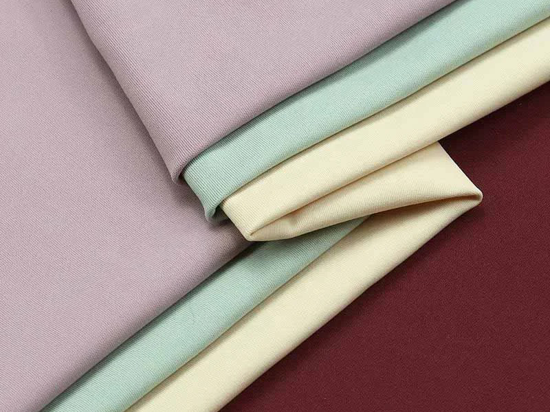 Folded knit fabric pieces in pastel and rich solid colors