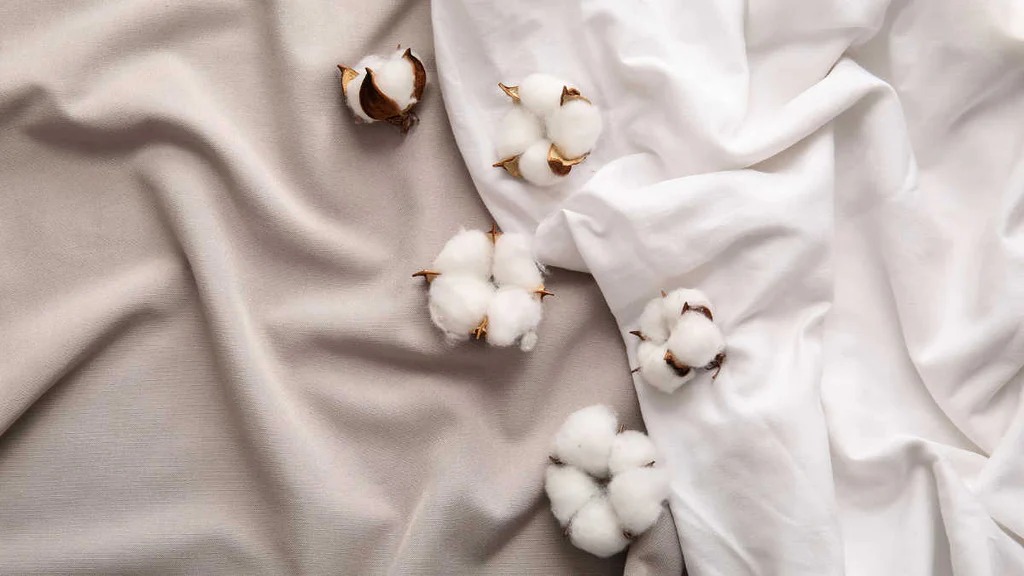 Soft draped fabric with cotton bolls in neutral textile composition
