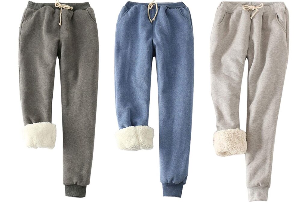 Three fleece-lined jogger pants in gray, blue, and beige with rolled sherpa cuffs.