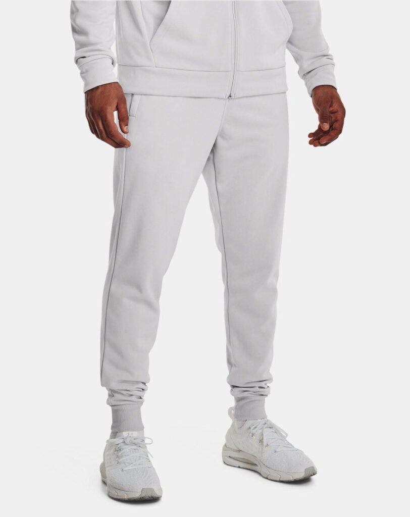 Man wearing light gray athletic joggers with tapered cuffs and white sneakers.