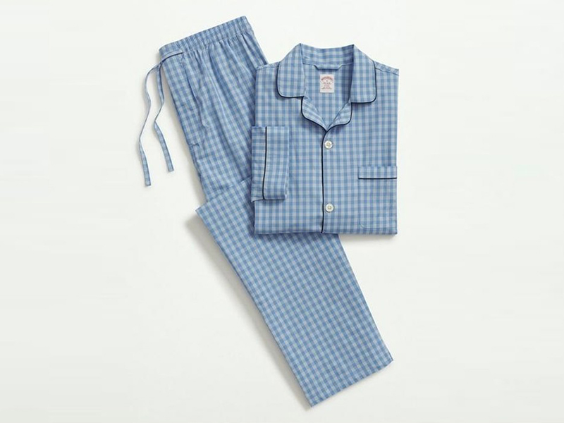 Folded blue gingham pajama set with button-up shirt and matching pants.