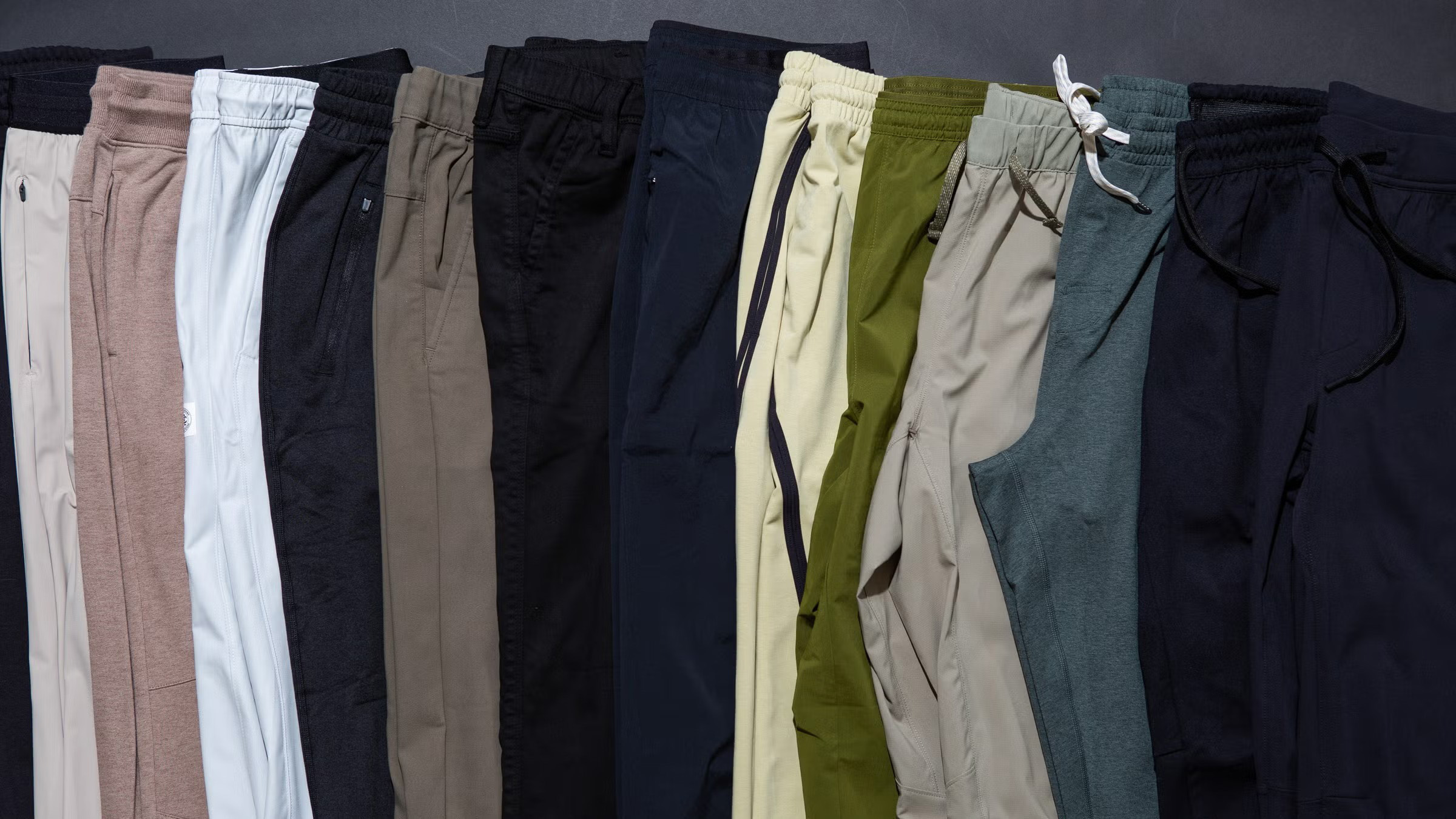 Assorted jogger pants in neutral and athletic colors displayed side by side