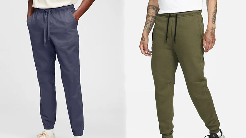 Men modeling tapered jogger pants in navy and olive with drawstring waists.