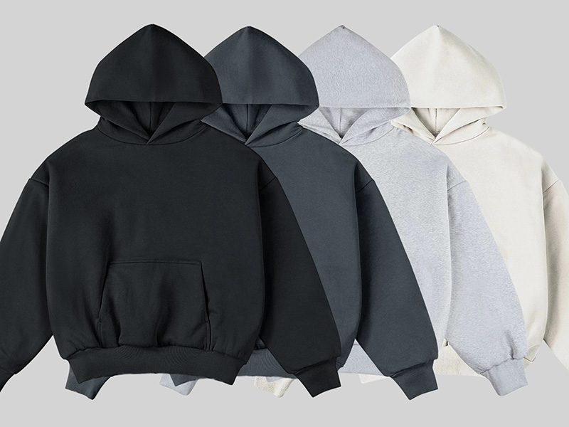 Four oversized hoodies in black, charcoal, gray, and cream tones.
