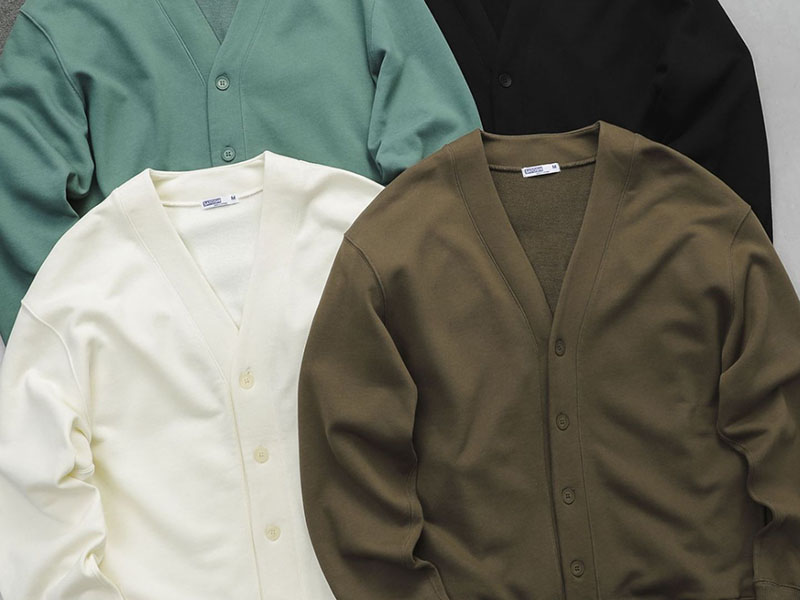 Four solid-color cardigans in mint, cream, olive, and black arranged flat