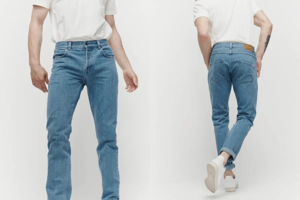 Man wearing light blue slim-fit jeans shown from front and back with cuffed hems.