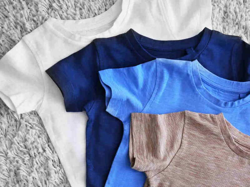 Stack of Polyester Nylon T-shirts in white, blue, and beige tones