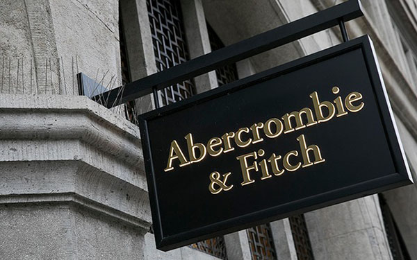 Black and gold store sign displaying "Abercrombie & Fitch" mounted on the exterior of a building.