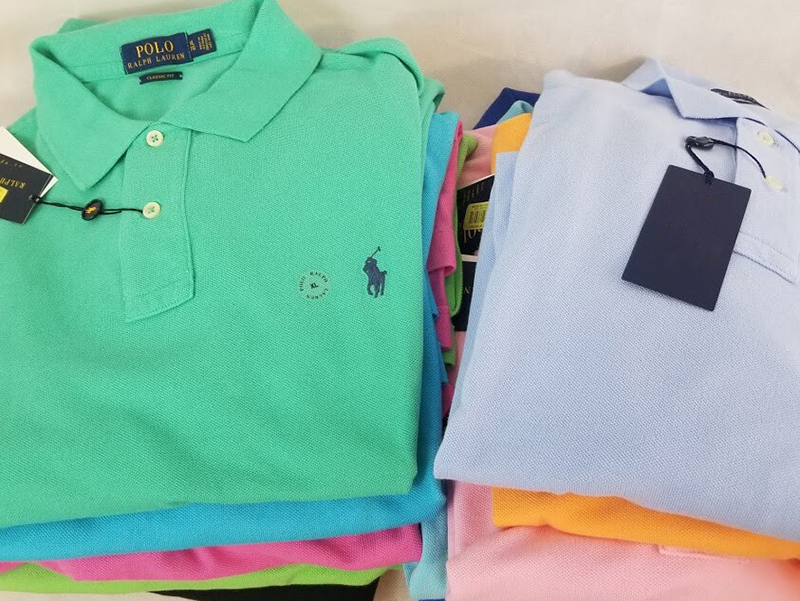 Folded colorful classic fit polo shirts with embroidered logo and retail tags