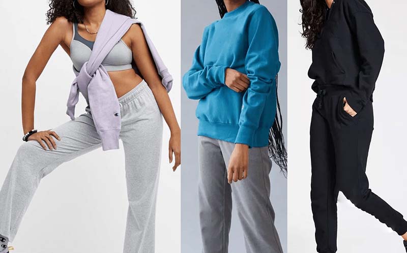 Three models wearing casual activewear: left in grey sweatpants and sports bra with lavender sweatshirt tied over shoulders, center in blue sweatshirt and grey pants, right in black hoodie and joggers.
