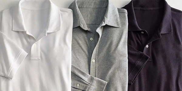 Folded polo shirts displayed in white, gray, and dark navy classic colors.