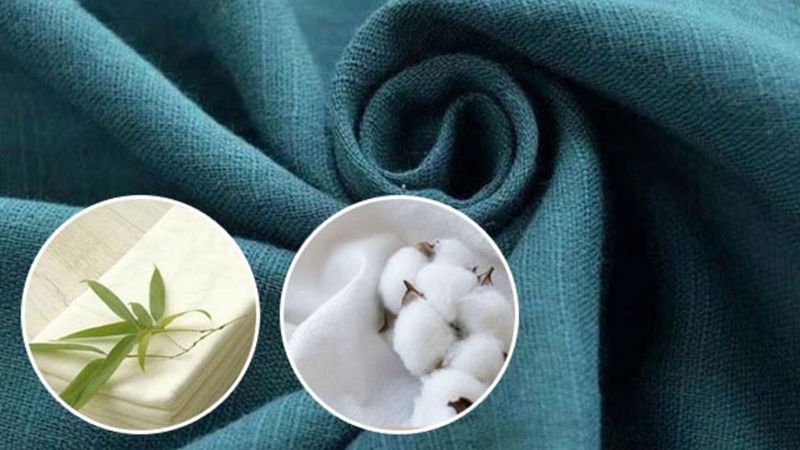 A teal-colored fabric swirled in the center with two circular insets showing raw materials: cotton bolls in one and a bamboo shoot with bamboo fibers in the other, illustrating the sources of textile fibers.