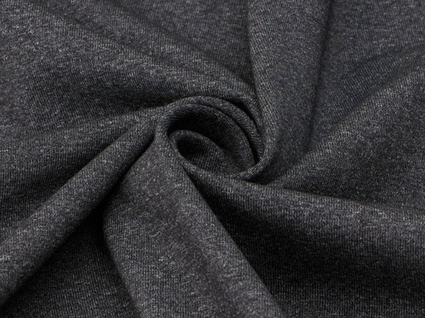 Close-up view of dark gray textile fabric twisted to show texture and stretch, highlighting soft knit material.