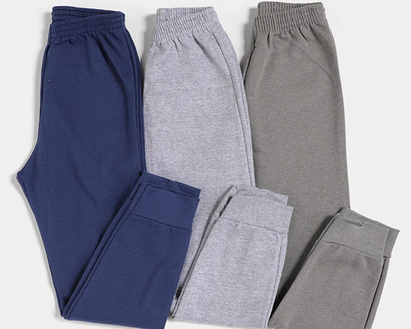Three fleece jogger pants in navy, light gray, and dark gray laid flat.