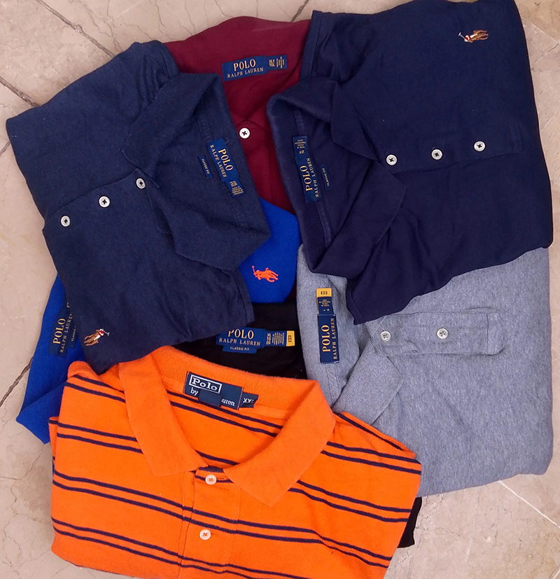 Assorted folded polo shirts in solid and striped classic casual styles