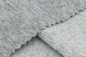 Gray French terry fabric showing both smooth outer side and looped inner side.