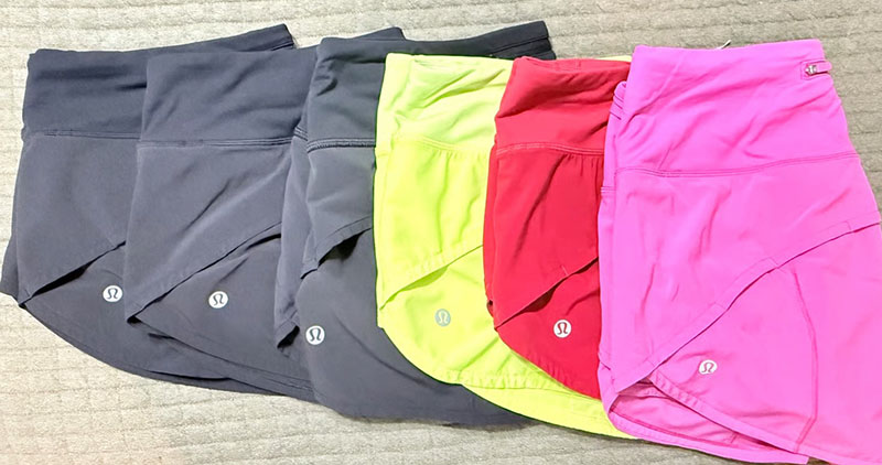 Colorful high-waist athletic shorts displayed in multiple vibrant and neutral shades