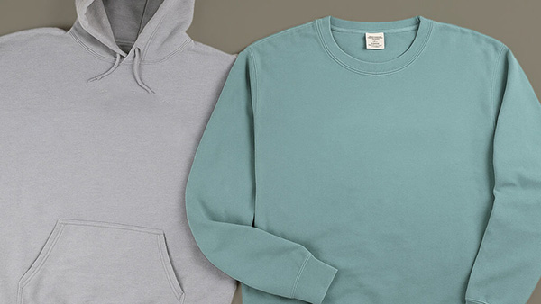 Gray pullover and mint crewneck sweatshirt displayed side by side in casual styles.