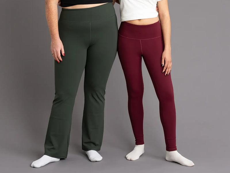 Two women wearing olive flare leggings and burgundy high-waisted leggings side by side.