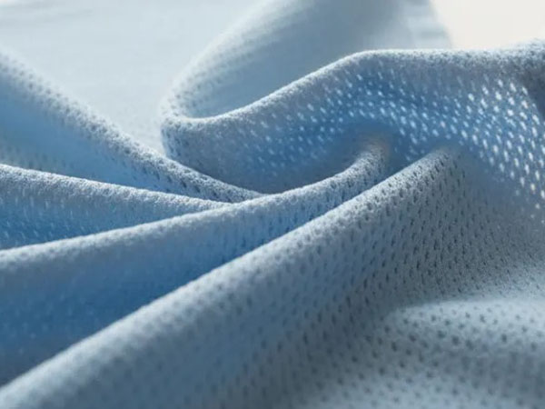 Soft blue microfiber mesh fabric with breathable perforated texture for sportswear