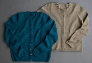 Blue and beige button-up knit cardigan sweaters displayed on gray background