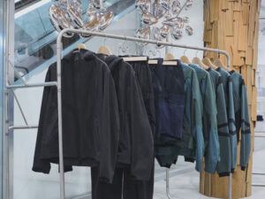 Rack of premium activewear jackets and apparel displayed in a contemporary retail showroom setting