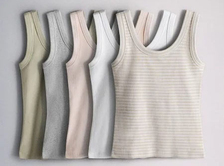 Five women’s tank tops in soft neutral shades, including striped beige style.