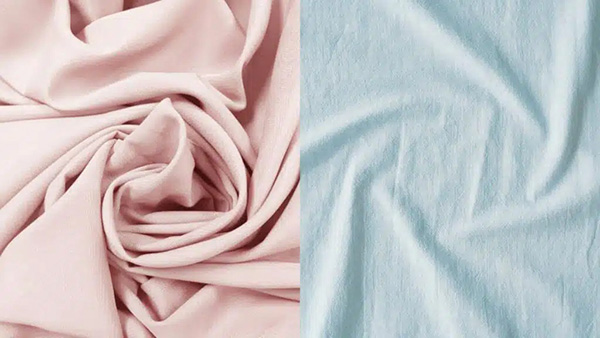 Soft draped fabric shown side by side in blush pink and light blue colors.