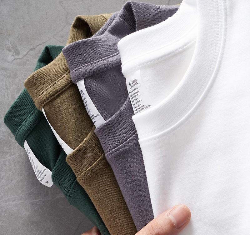 Folded premium cotton T-shirts in neutral colors with soft crewneck design
