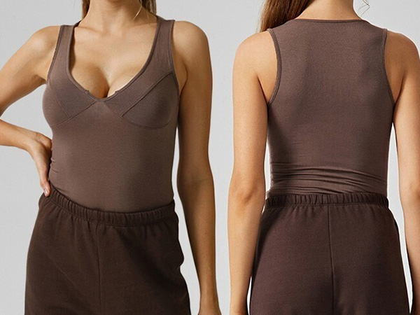 Woman wearing a fitted dark brown sleeveless tank top with a scoop neckline, tucked into dark brown elastic-waist pants.