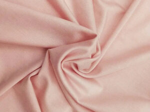 Light pink stretch fabric with smooth texture and elegant folded drape for apparel manufacturing and fashion design