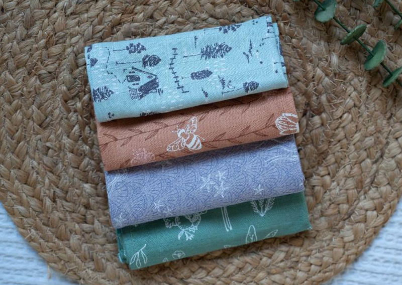 Four folded pieces of patterned fabric in pastel shades