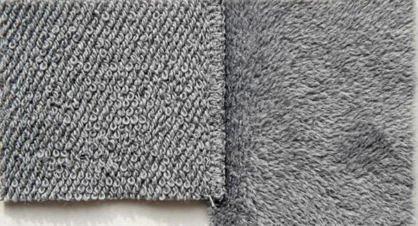 Gray fabric sample showing looped terry backing beside soft brushed fleece texture.