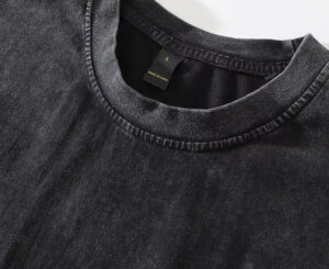 Close-up of vintage washed black cotton t-shirt collar and fabric texture