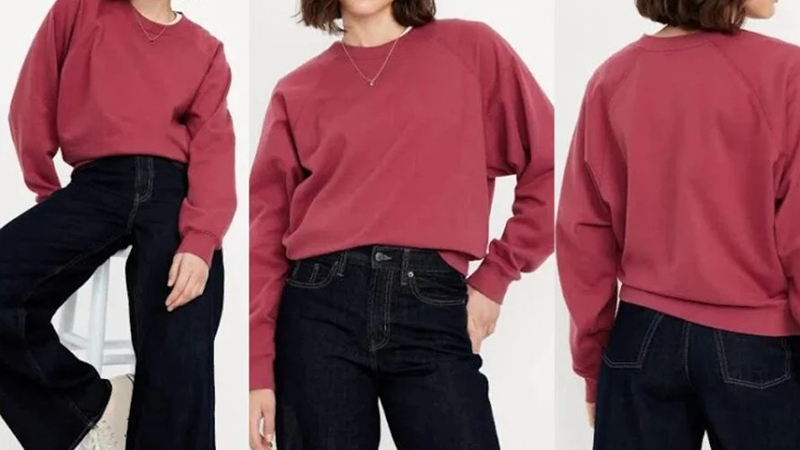 Woman wearing a rose pink cropped sweatshirt with dark wide-leg jeans in front and back views.