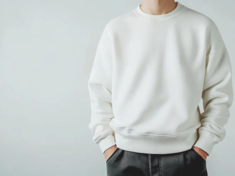 Close-up of white French terry sweatshirt with ribbed cuffs.