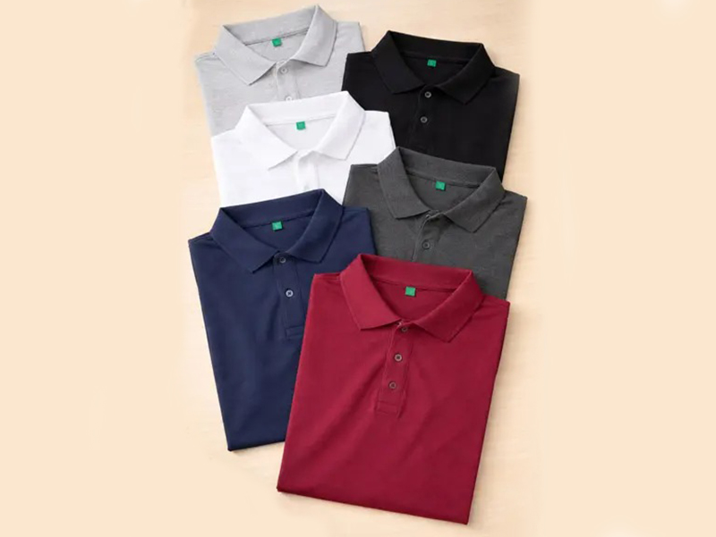 Folded cotton polo shirts in assorted colors displayed neatly for casual uniform and fashion apparel collection showcase