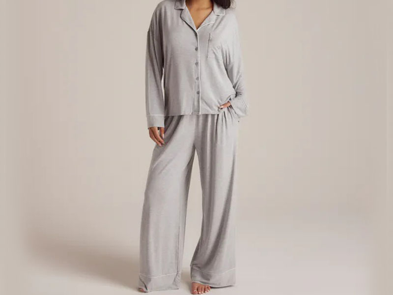 Woman wearing soft gray long-sleeve pajama set with relaxed fit and wide-leg lounge pants for comfortable sleepwear style