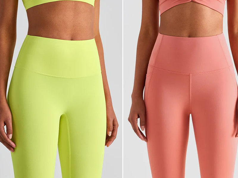 Two women wearing high-waist active leggings, one in lime green and the other in coral pink, shown from waist to mid-thigh.