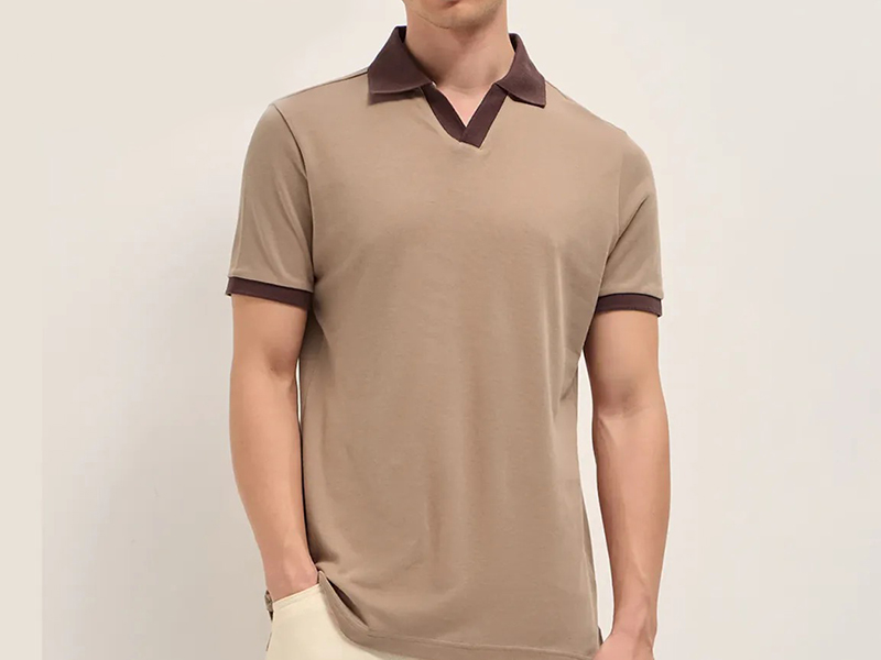 Man wearing taupe short-sleeve polo shirt with contrasting brown collar and sleeve trim.