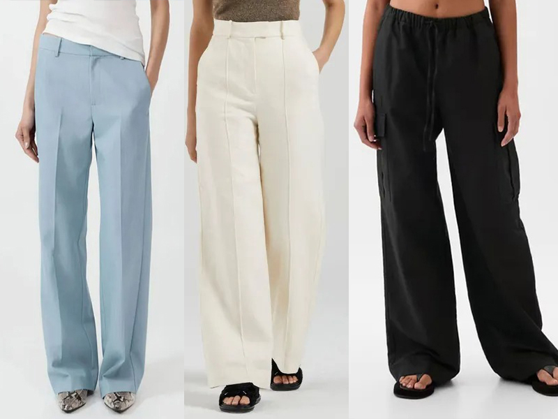 Three women wearing wide-leg pants in blue, white, black