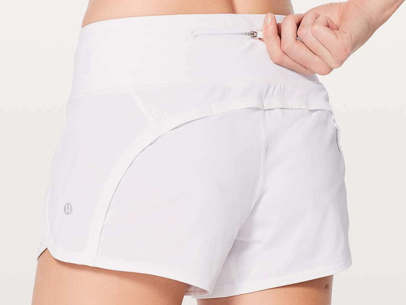 White athletic running shorts with hidden zipper pocket on waistband