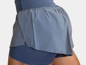 Blue women’s athletic shorts with built-in compression layer and lightweight flowy outer fabric design