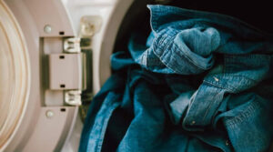 Blue denim clothes inside washing machine during garment washing process