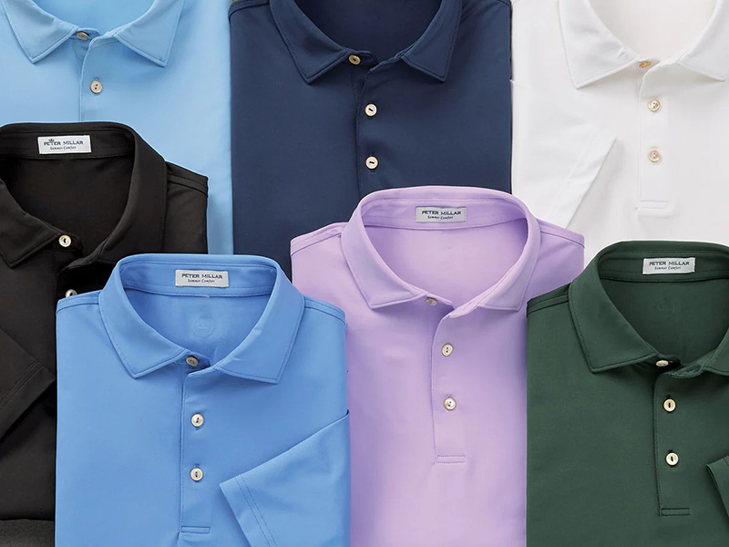 Assorted men’s polo shirts folded in black, blue, white, lavender, and green colors.