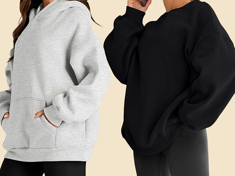 Oversized gray hoodie and black crewneck sweatshirt shown in casual relaxed fits.