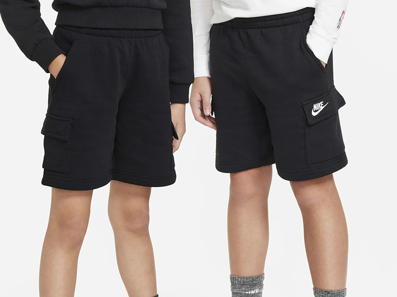 Men wearing black cargo shorts with side pockets, elastic waistband, and soft fleece fabric, designed for casual comfort, active play, and everyday wear.