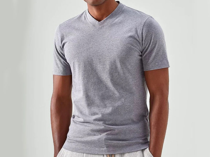 Man wearing a fitted gray V-neck T-shirt, showcasing a classic casual style, clean silhouette, and versatile everyday wardrobe essential.