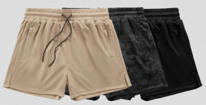 Three pairs of athletic mesh shorts in beige, black camo, and solid black, casual sportswear for men